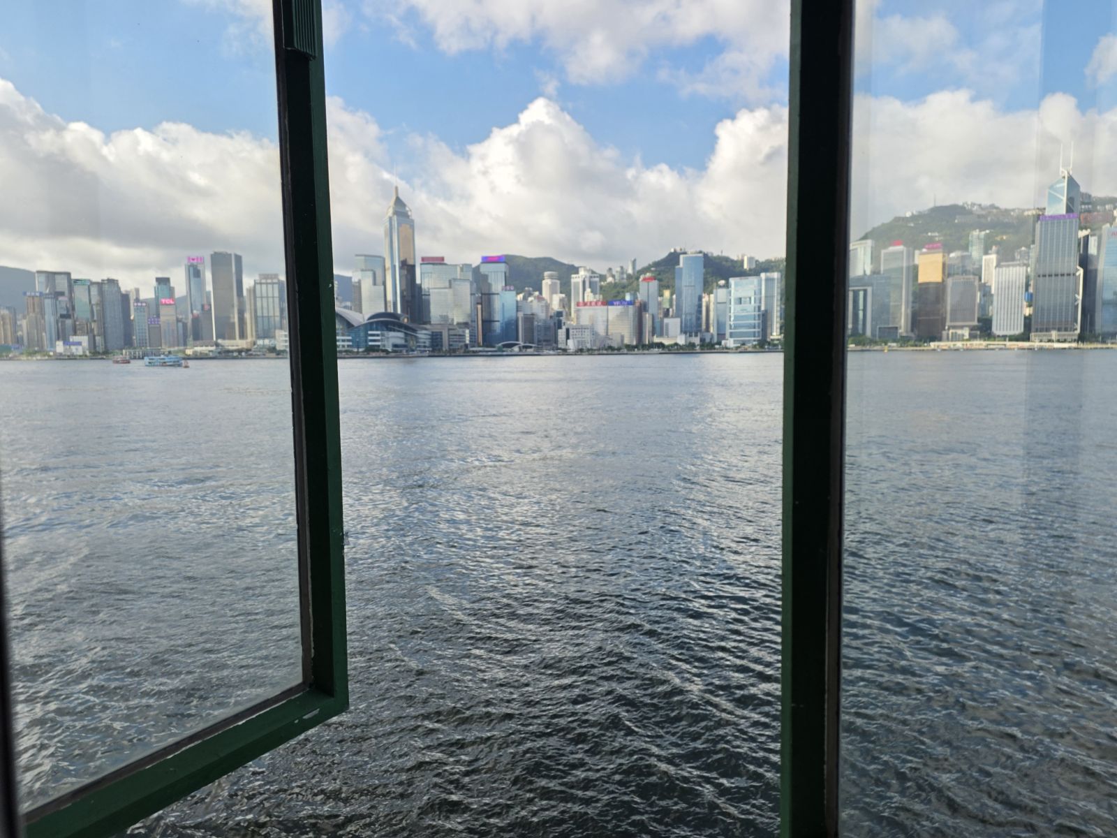 Hong Kong skyline across Victoria Harbour, seen through a Star Ferry window